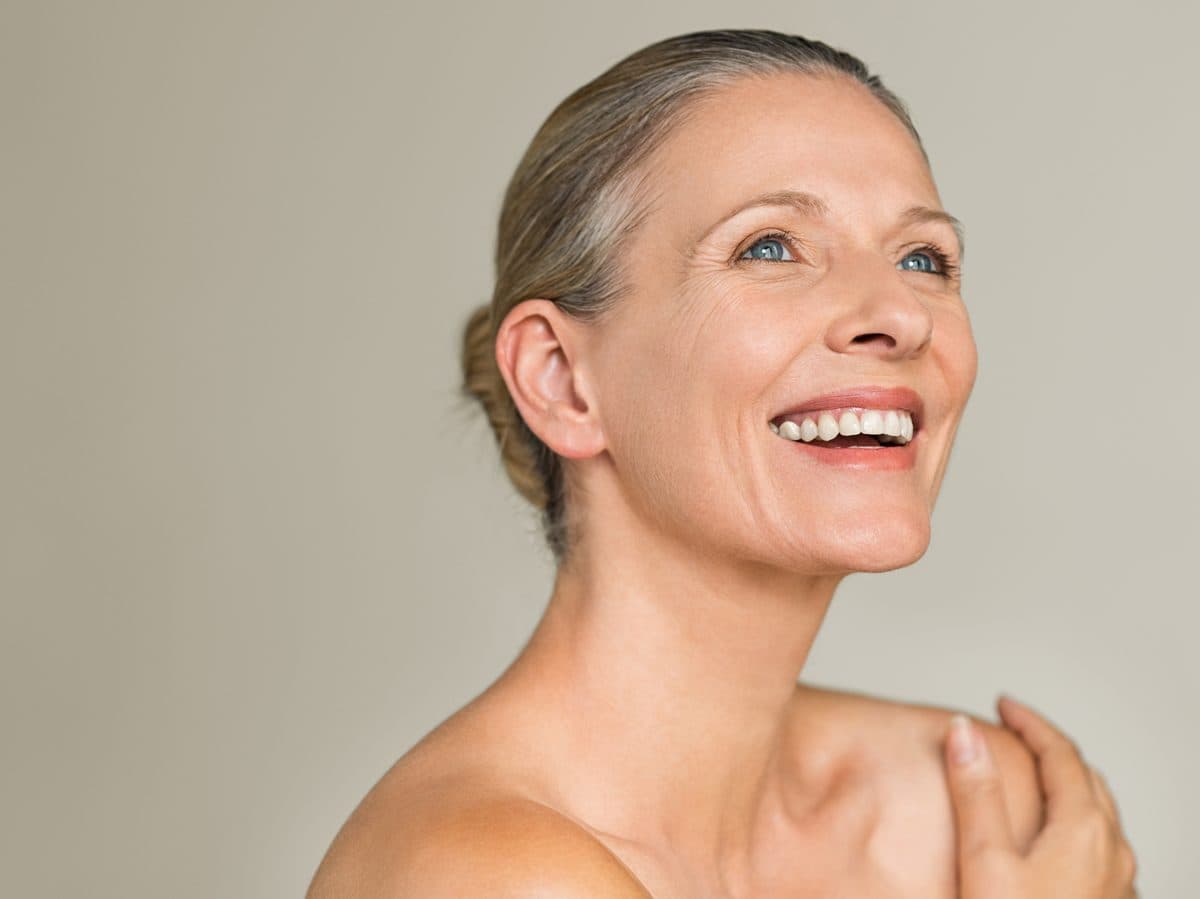 Woman considering breast augmentation or breast lift in a relaxed Australian setting